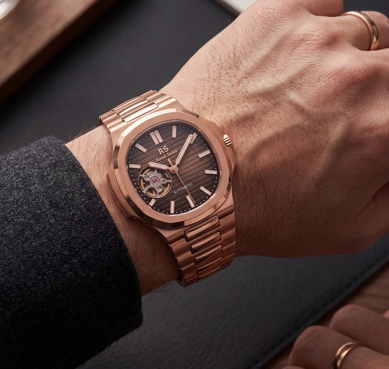 Rose gold watch worn on a wrist